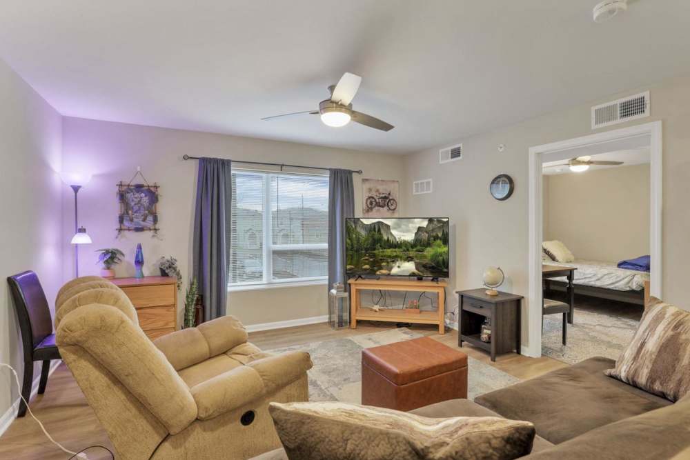 Well-lit living room with a window at McKinley Manor in Columbus, Ohio 