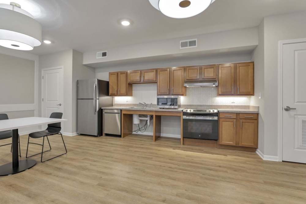 Kitchen with wooden cabinets and appliances at McKinley Manor in Columbus, Ohio
