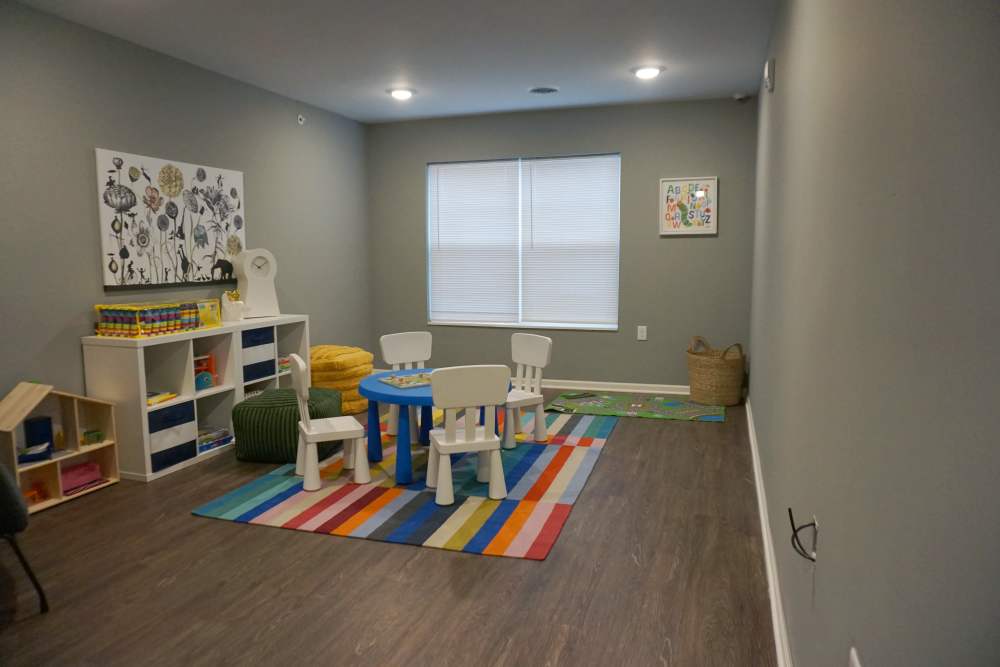 Children's playroom with colorful rug at Wendler Commons in Columbus, Ohio