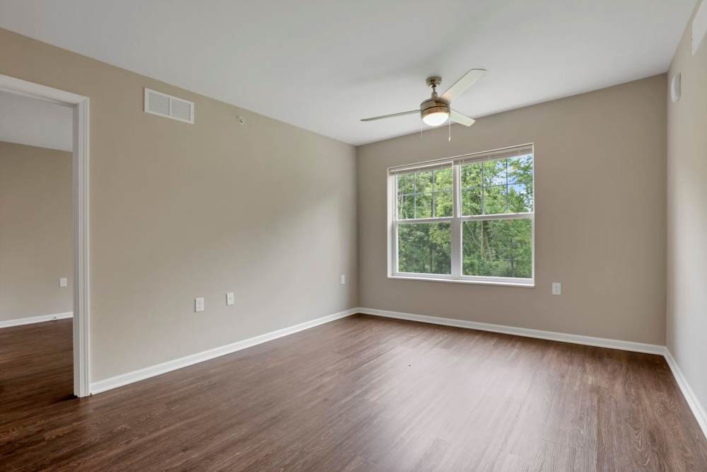 Spacious bedroom with wood-style flooring at Wendler Commons in Columbus, Ohio