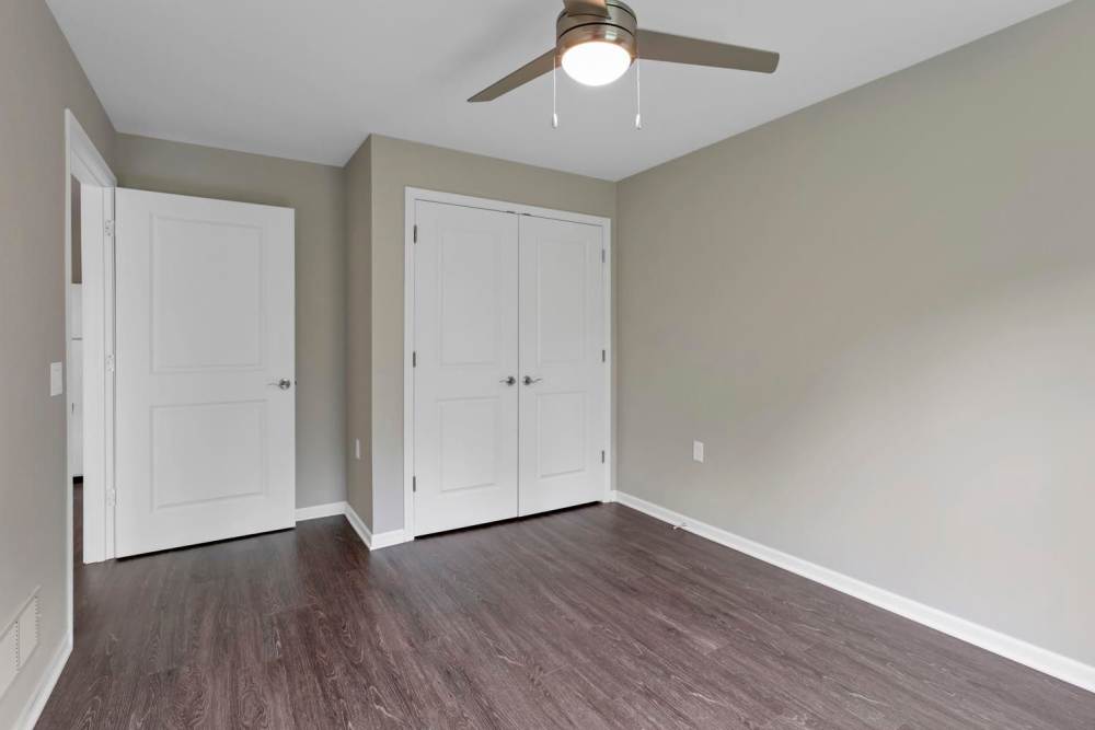 Bright room with ceiling fan and closet at Wendler Commons in Columbus, Ohio