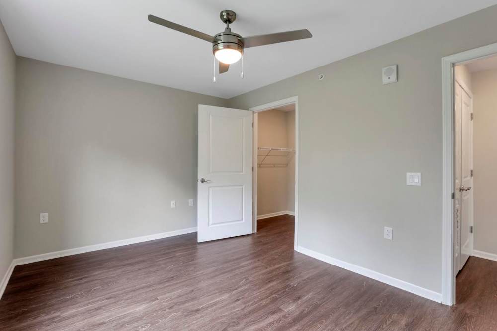 Bright bedroom with ceiling fan and closet at Wendler Commons in Columbus, Ohio