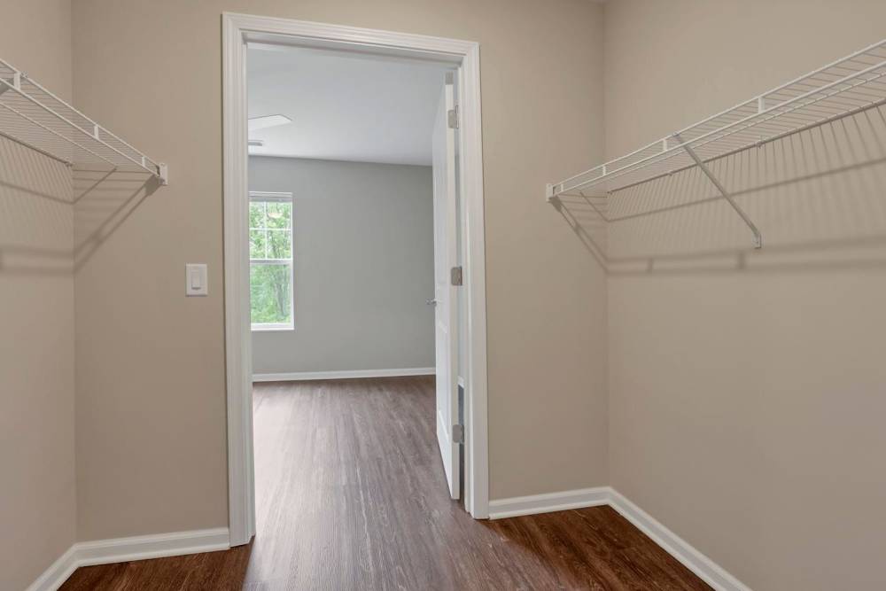 Spacious walk-in closet with wood-style flooring at Wendler Commons in Columbus, Ohio