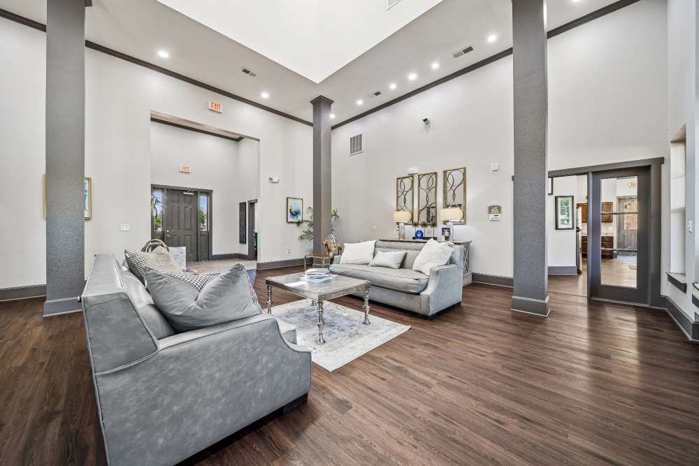 Lounge area with entry door in background in clubhouse at Blue Ridge in Midland, Texas