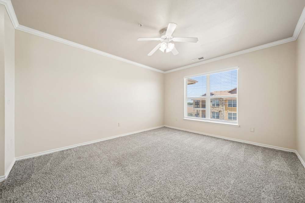 Empty living room with carpet flooring and nine foot ceilings of apartment at Blue Ridge in Midland, Texas