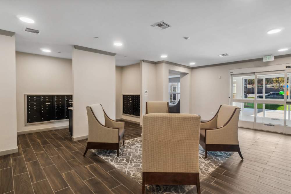 Lobby seating area with chairs, rug, and mailboxes at Eagle Park Vistas in Hanover, Maryland