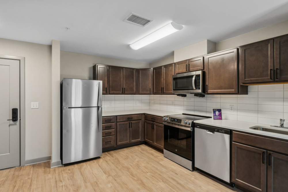 Modern kitchen with stainless steel appliances and dark cabinets at Eagle Park Vistas in Hanover, Maryland