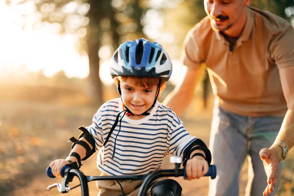 A kid riding a bicycle on a scenic path at Mosaic in Shelton, Connecticut
