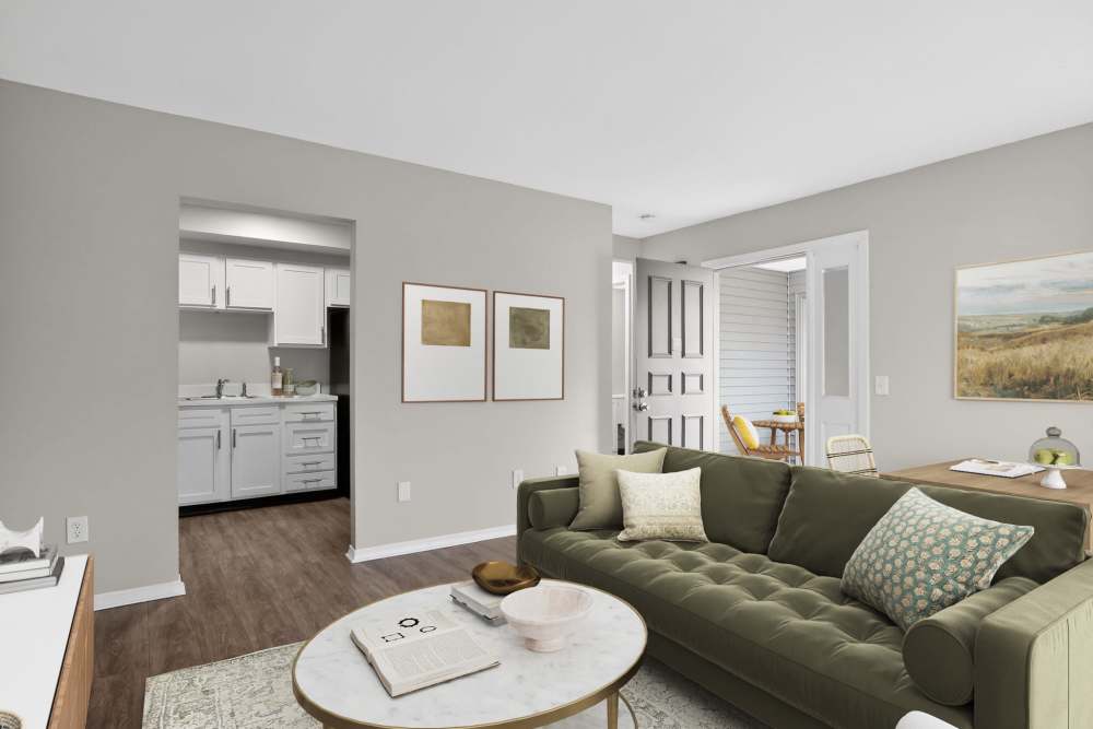 Hand opening a modern oven with stainless steel accents in a sleek kitchen at The Flats at Talcott in Weatogue, Connecticut