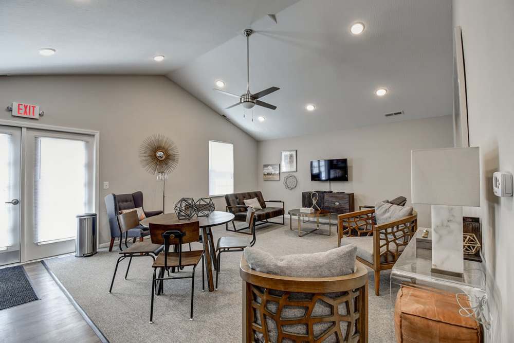Bright community lounge with comfortable seating, modern decor, and large windows for natural light at Labelle Greene I in Wheeling, West Virginia
