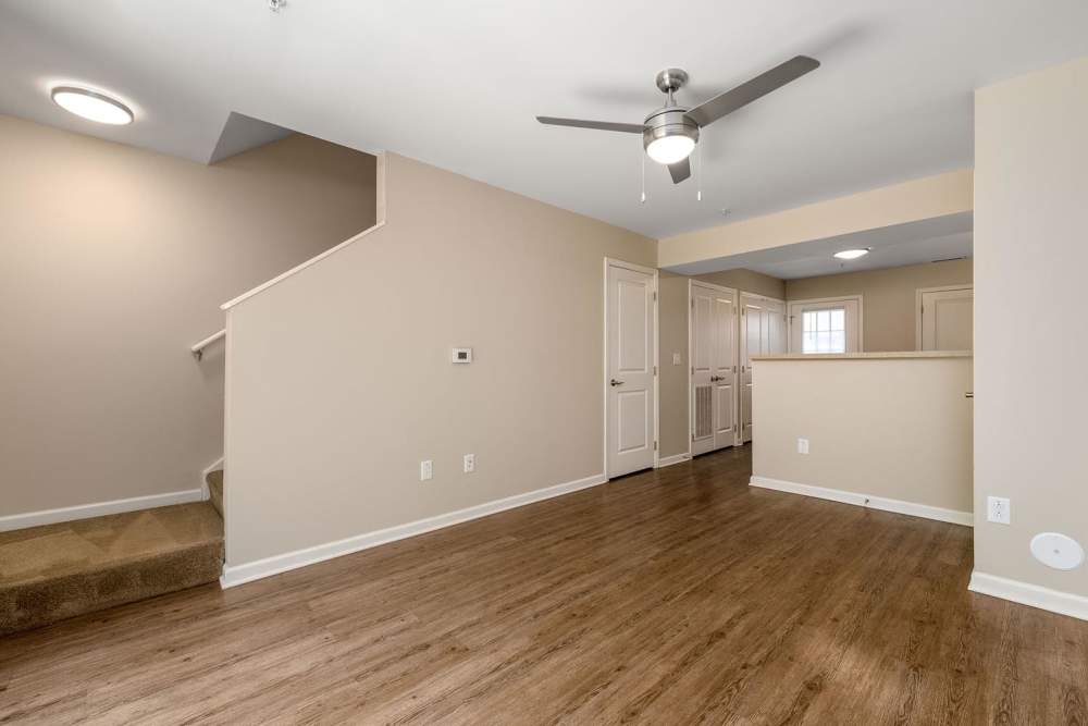 Open layout with wood-style flooring and ceiling fan, staircase leading to upper level at Labelle Greene III in Wheeling, West Virginia