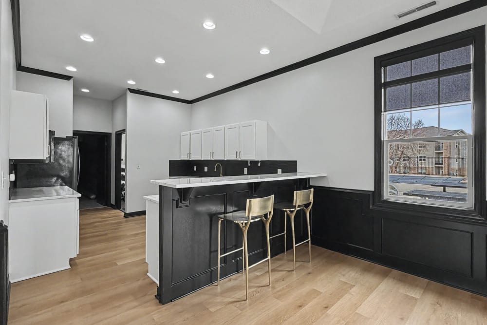 Kitchen with white cabinetry at Pointe 28 in Ankeny, Iowa