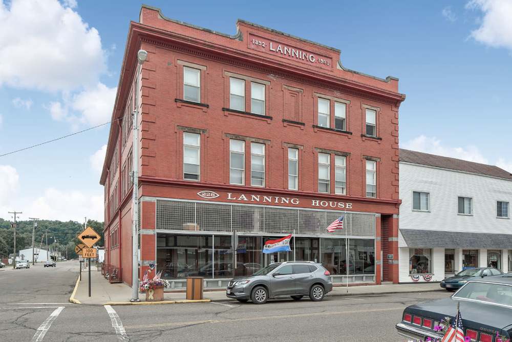 Historic brick building with storefronts near Lanning House in Dennison, Ohio
