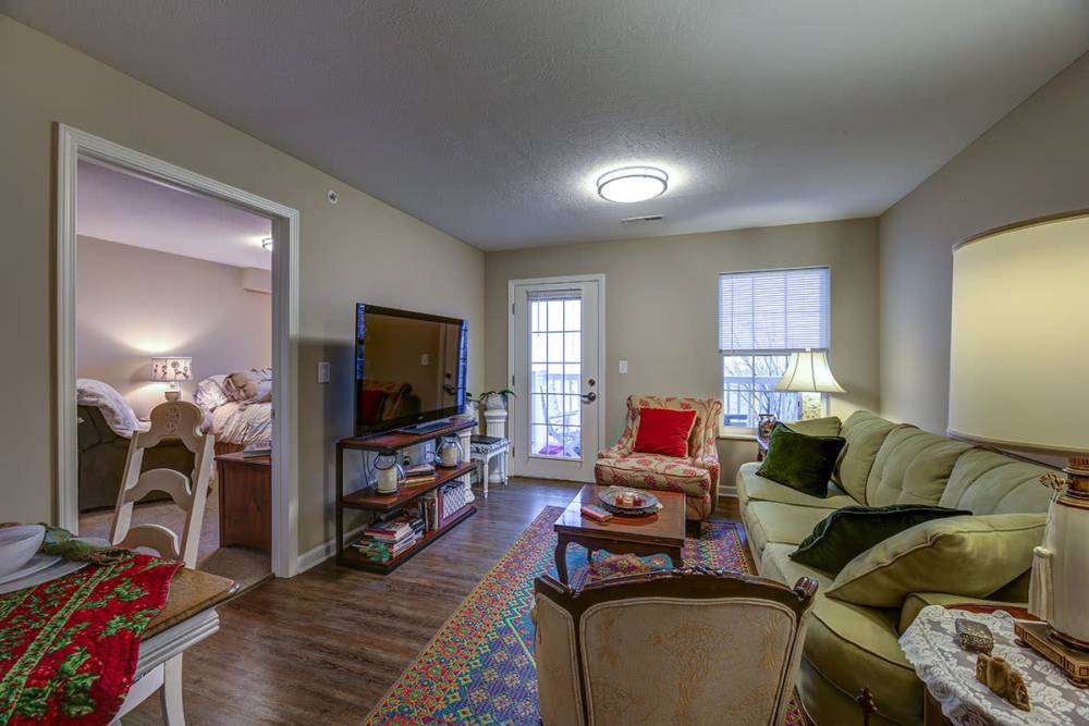 Modern living room with a TV at Willoughbeach Terrace Senior Living in Willowick, Ohio 