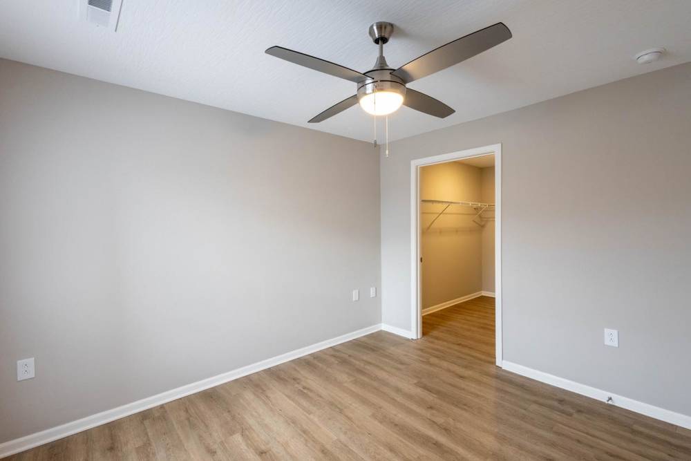 Spacious bedroom with wood-style flooring at Zane Commons in Zanesville, Ohio