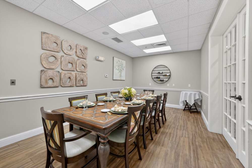 Private dining room with long table and place settings at The Barclay at Vero Beach in Vero Beach, Florida