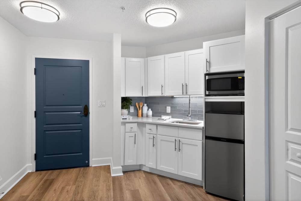 Apartment kitchen with white cabinets and stainless appliances at The Barclay at Vero Beach in Vero Beach, Florida