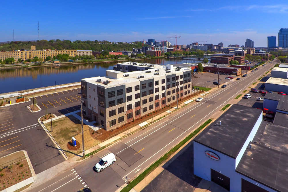 Modern apartment community with waterfront views and nearby parking spaces at Grand View Place in Grand Rapids, Michigan