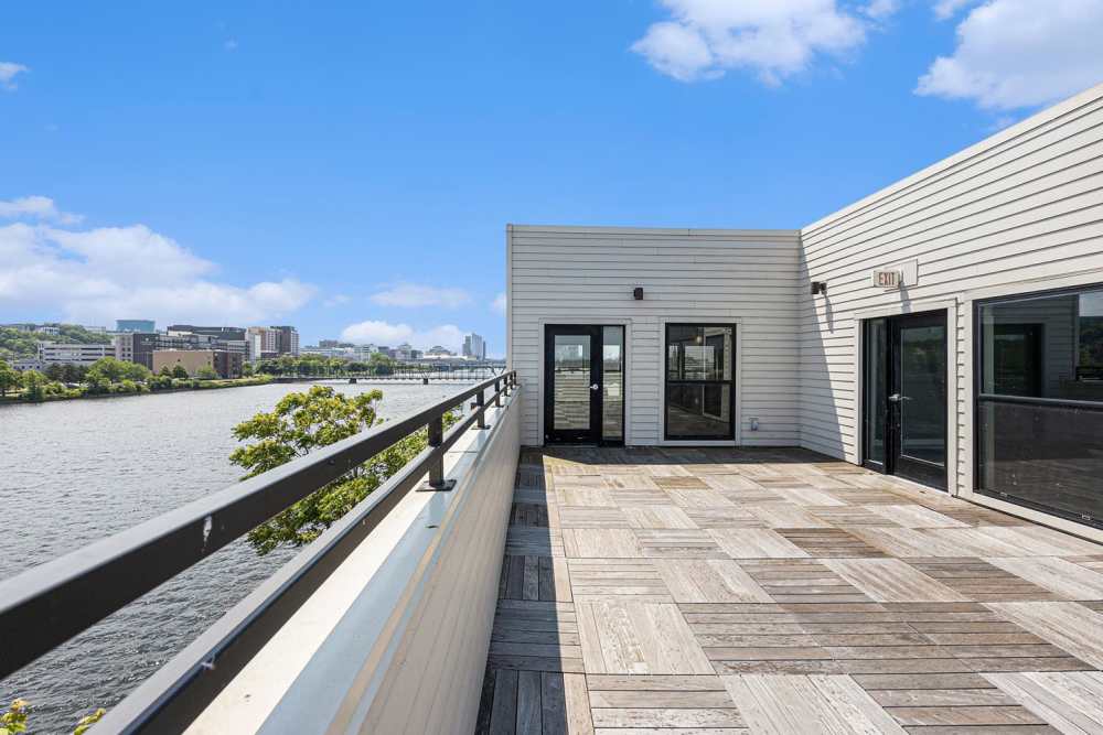 Spacious outdoor patio with river views and modern wood-style flooring at Grand View Place in Grand Rapids, Michigan