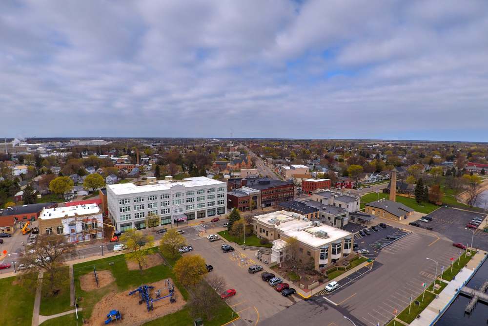 Aerial view of a vibrant community with parks, residential buildings, and commercial spaces at Lloyd House I in Menominee, Michigan