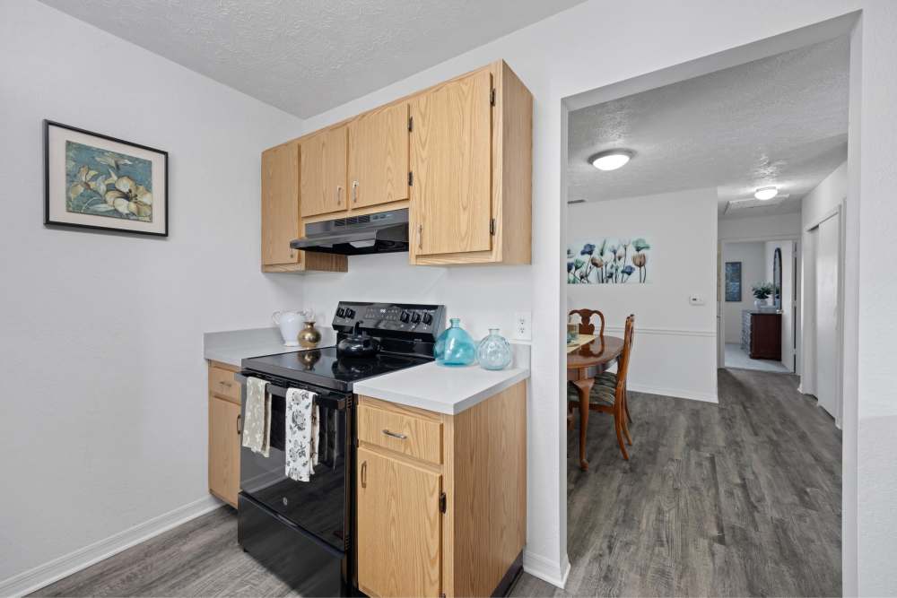 Kitchen with range, hood and storage spaces at Carlton Arms Of South Lakeland in Lakeland, Florida