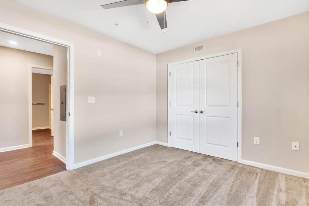 Spacious bedroom with featuring double doors and neutral walls at Rivergate Greene in Charlotte, North Carolina