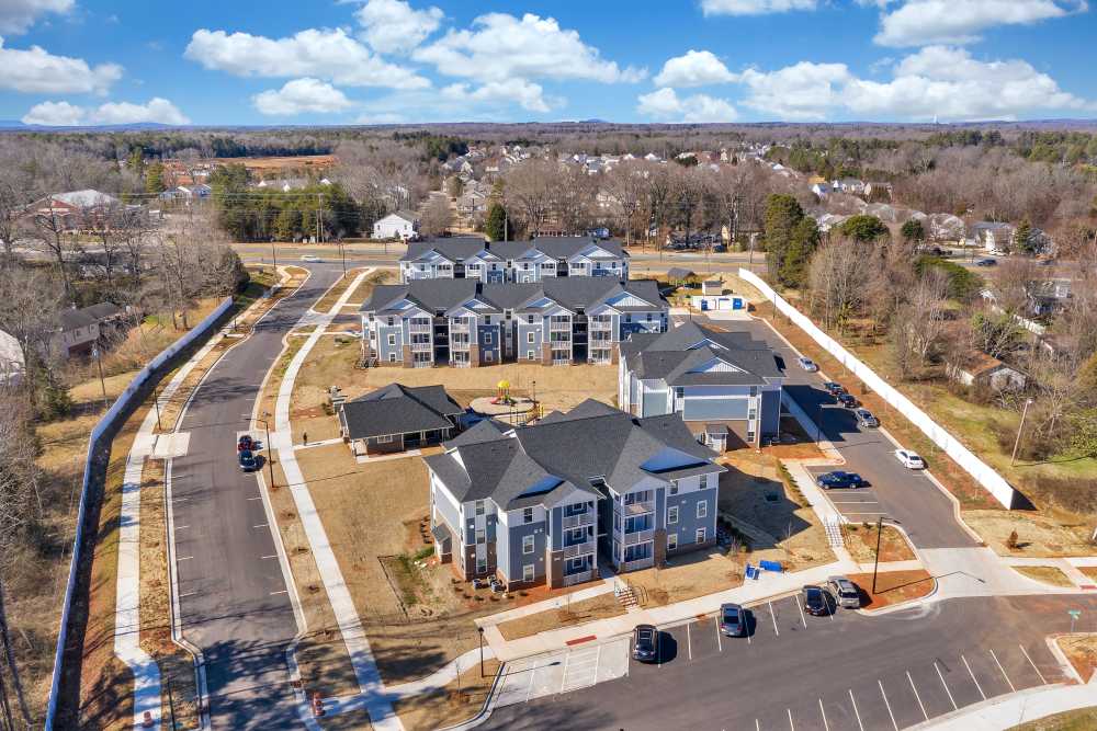 Aerial view of modern apartment community with parking areas at Rivergate Greene in Charlotte, North Carolina