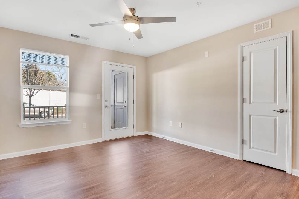 Spacious living area wit natural light from large windows at Rivergate Greene in Charlotte, North Carolina