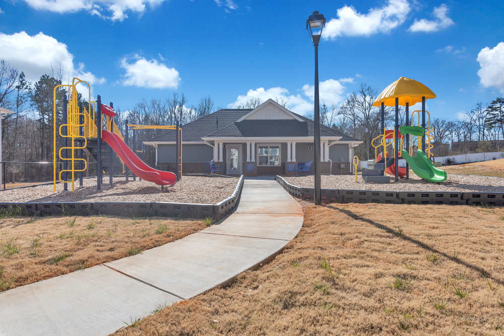 Playground with community building in the background at Rivergate Greene in Charlotte, North Carolina