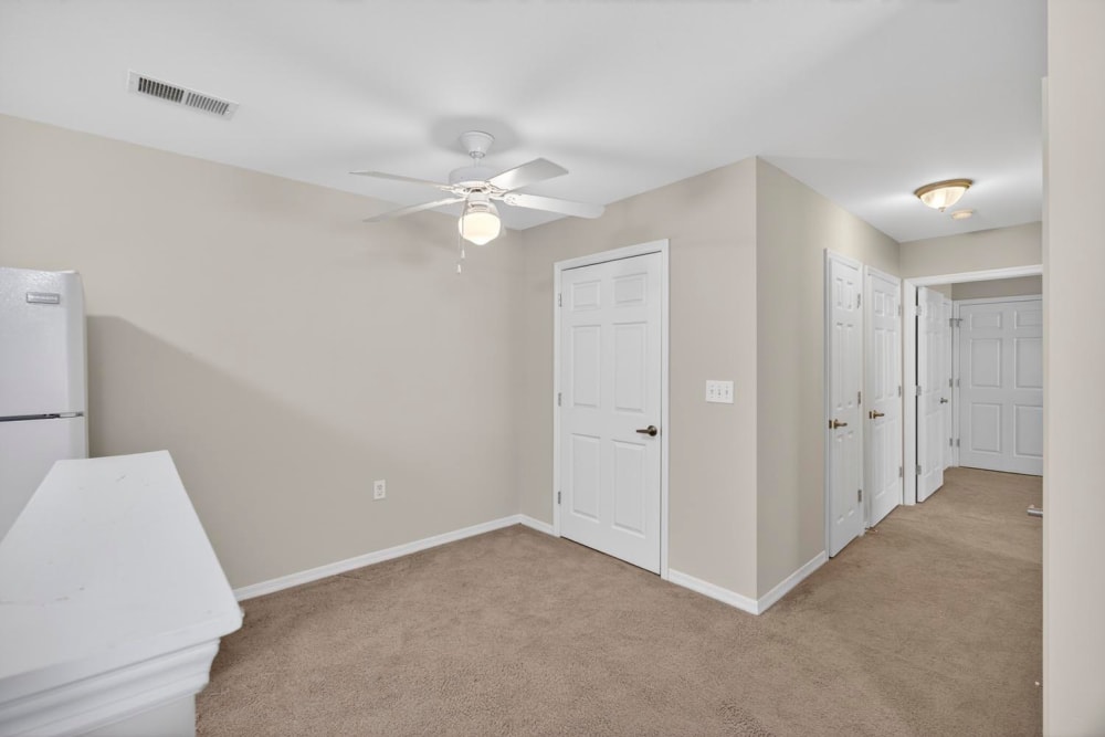 Living room with carpet flooring and ceiling fan at Crowfield Greene in Goose Creek, South Carolina