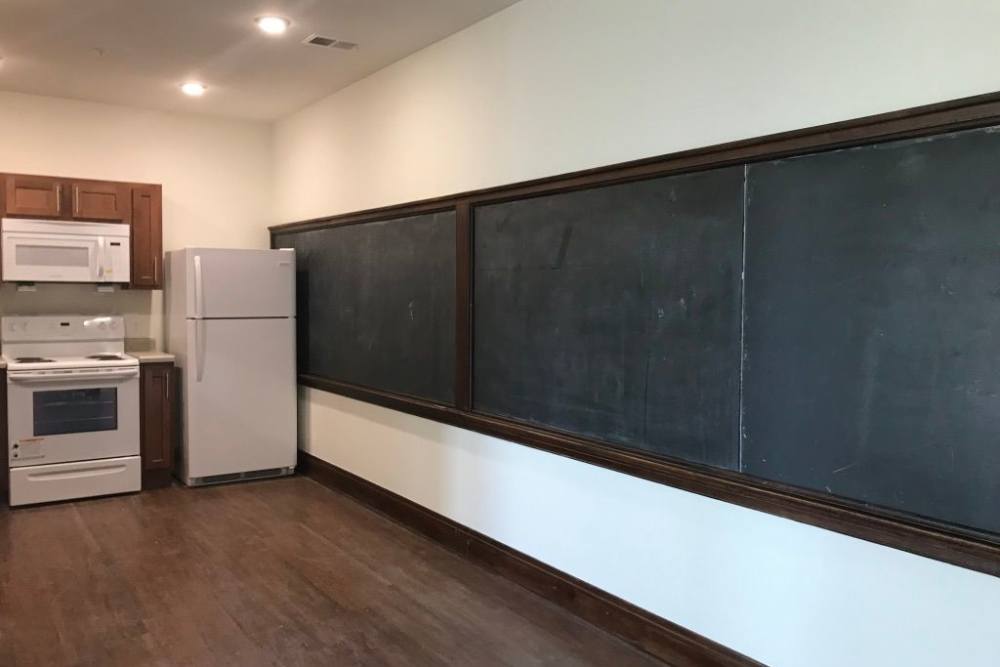 Open layout kitchen with chalkboard walls at Everts Hill Senior Living Apartments in Circleville, Ohio