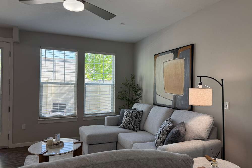 Living room with a ceiling fan at The Enclave in Meridian, Idaho