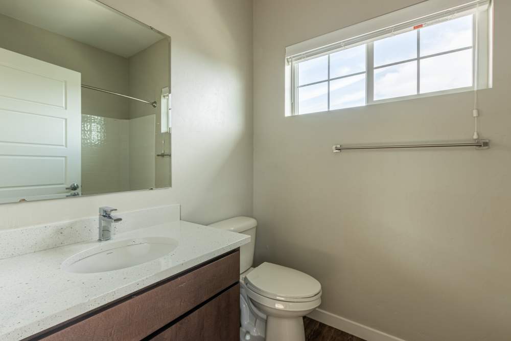 Bathroom with a toilet and a larger mirror at The Enclave in Meridian, Idaho