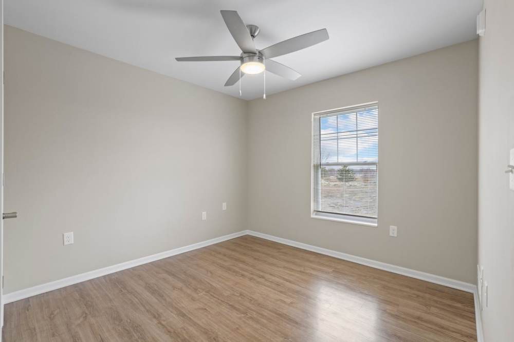 Bedroom with a large window and a ceiling fan at Dunbury Greene in Columbus, Ohio 