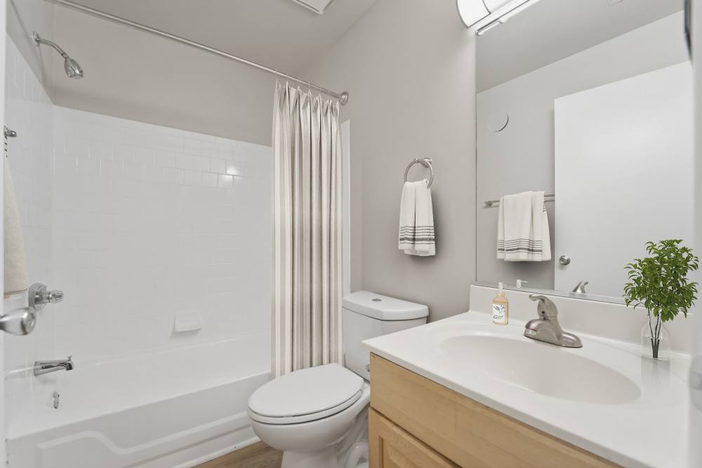 Bathroom with a toilet and a bathtub at Eagle Rock Apartments at Belcamp in Belcamp, Maryland