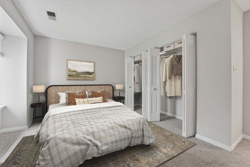 Well-lit bedroom with a comfortable bed at Eagle Rock Apartments at Belcamp in Belcamp, Maryland