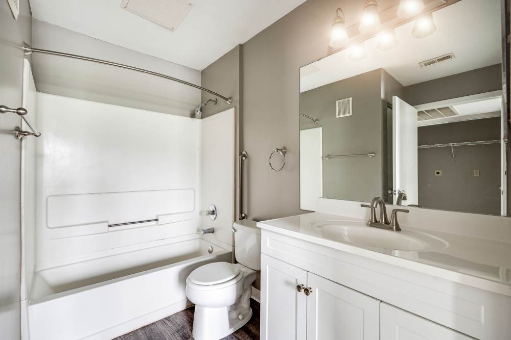 Bathroom with tub shower, toilet, and vanity at Ashton Glen in Centerville, Ohio