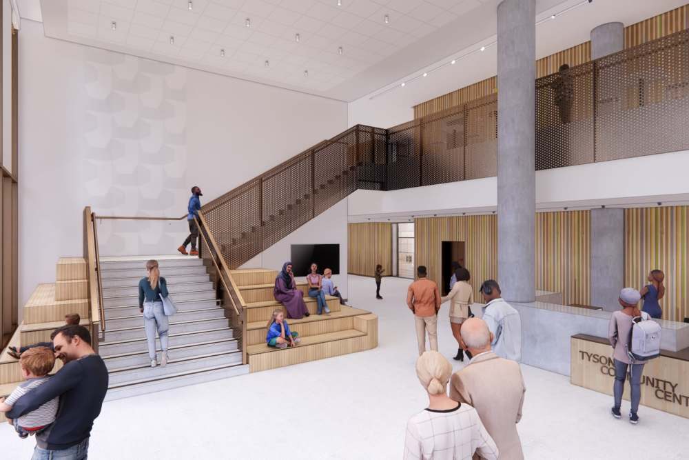 Community center lobby at The Exchange at Spring Hill Station featuring open staircase, seating tiers, and modern interior finishes