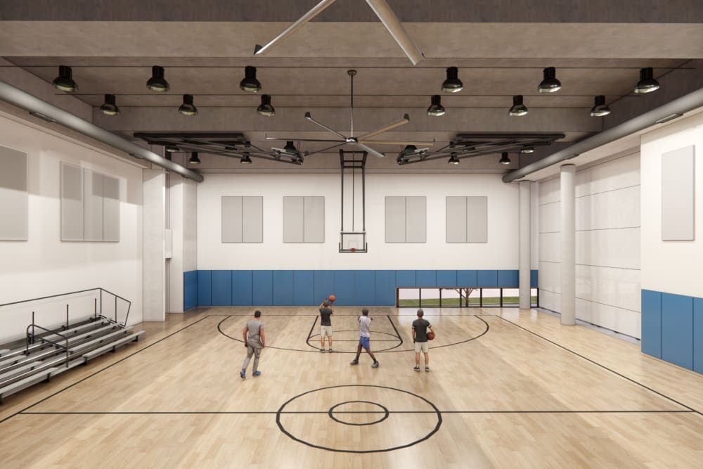 Large indoor fitness and recreation space at The Exchange at Spring Hill Station featuring basketball court and open activity area