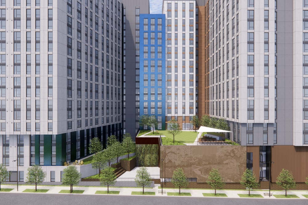 Courtyard view at The Exchange at Spring Hill Station featuring landscaped green space, outdoor seating, and surrounding residential buildings