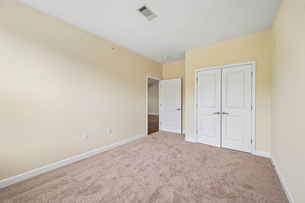 Unfurnished bedroom with walk-in closet at Burgess Mill Station in Ellicott City, Maryland