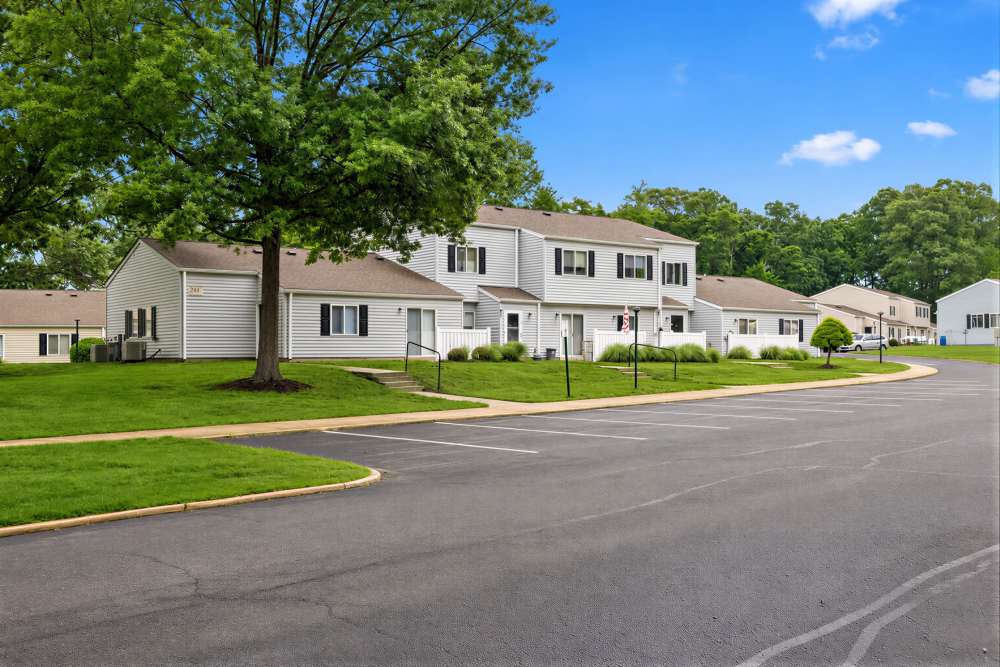 Townhome community exterior with parking lot and trees, Palmer in Waldorf, Maryland