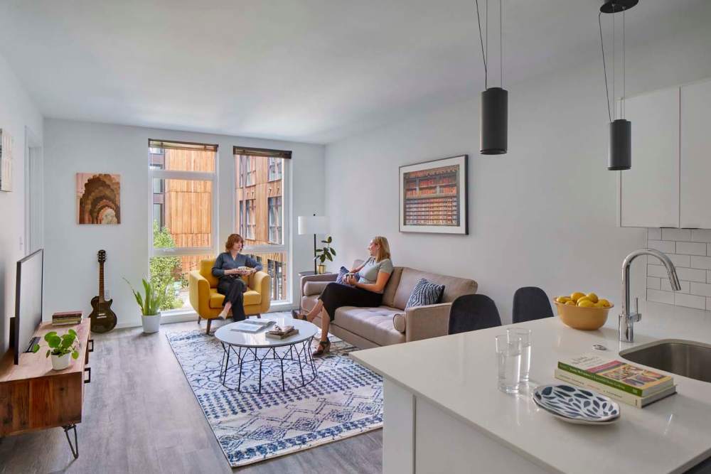 Residents sitting in a furnished living room at The Cooper in Wilmington, Delaware
