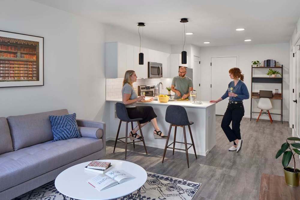 Residents at the island in their kitchen at The Cooper in Wilmington, Delaware