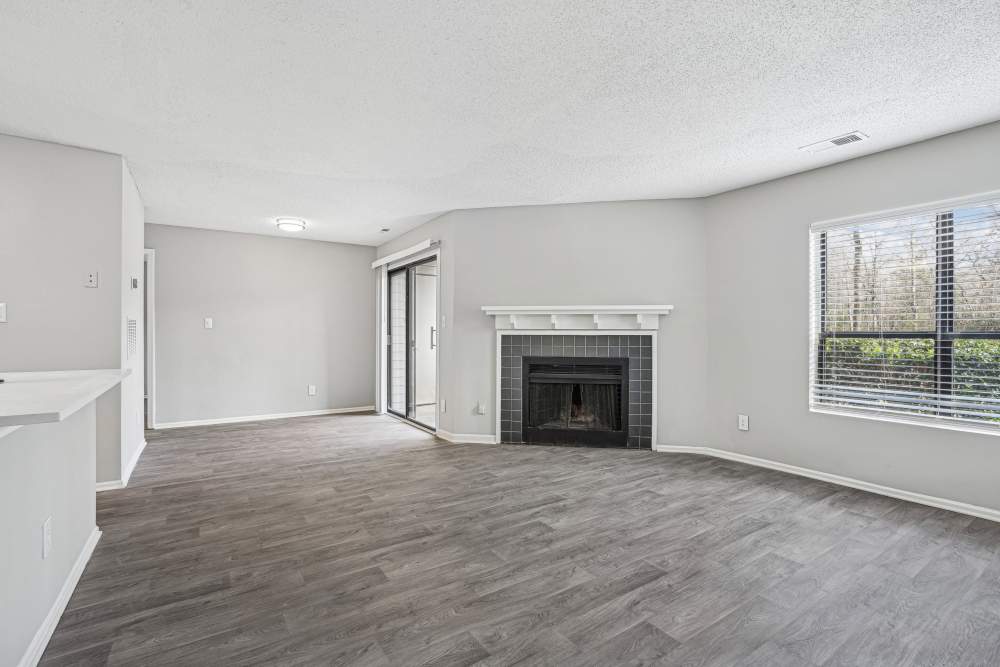 Unfurnished living room with a fireplace at Niner Woods in Charlotte, North Carolina