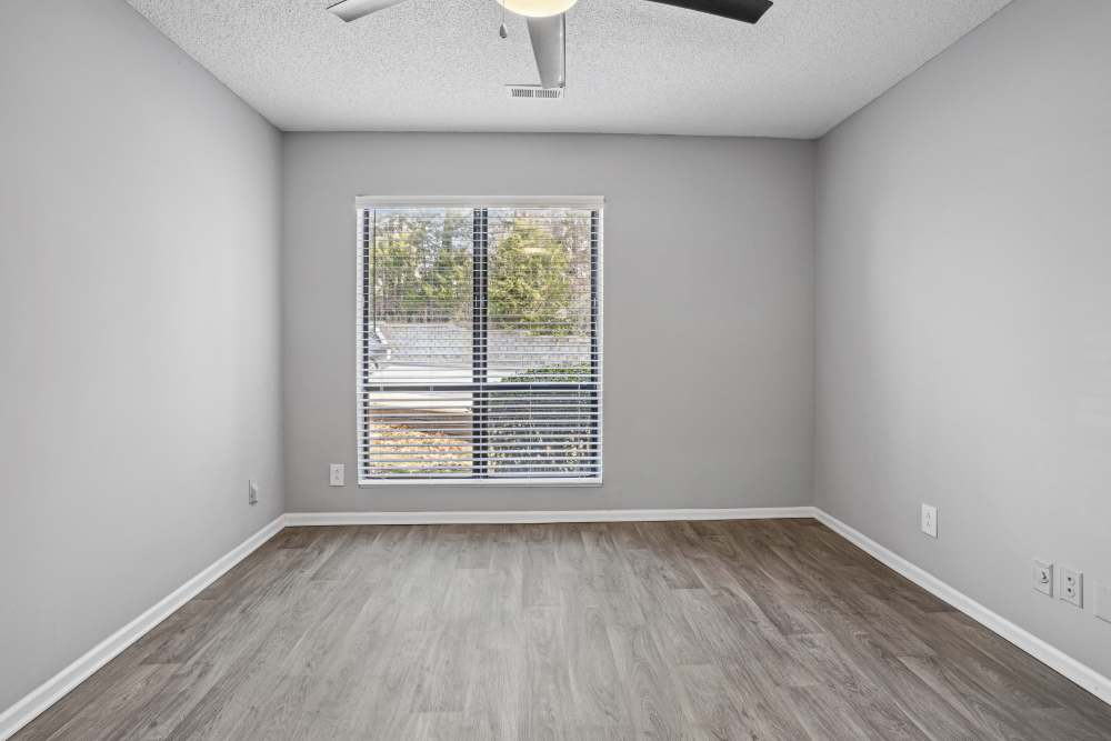 Empty bedroom with wood-style flooring at Niner Woods in Charlotte, North Carolina