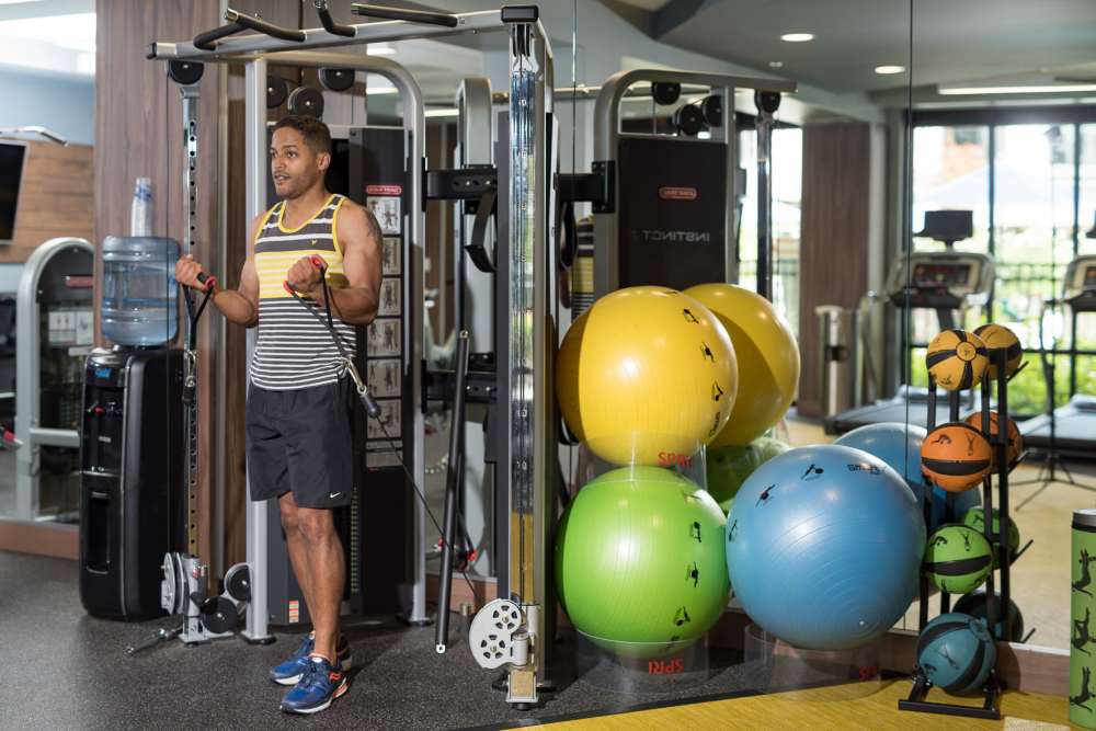 A resident working out i the fitness center at Harlan Flats in Wilmington, Delaware