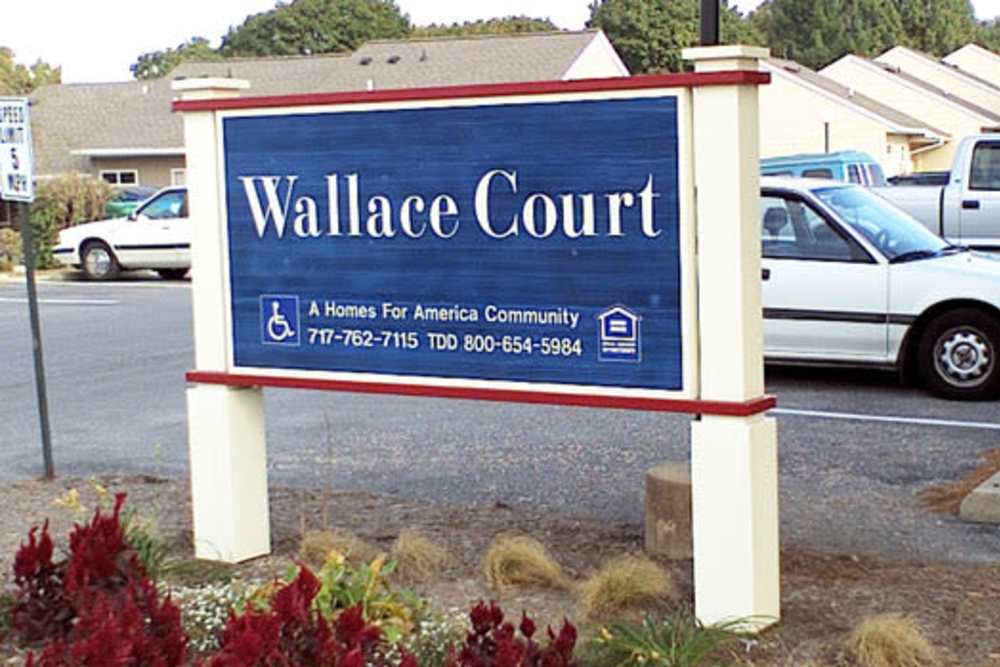 Community Sign board and parking cars at Wallace Court Apartments in Waynesboro, Pennsylvania