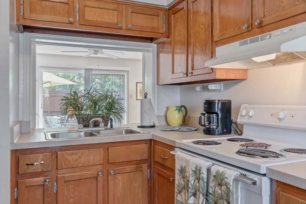 Kitchen with wooden cabinets at Carlton Arms Of St. Petersburg in St Petersburg, Florida 