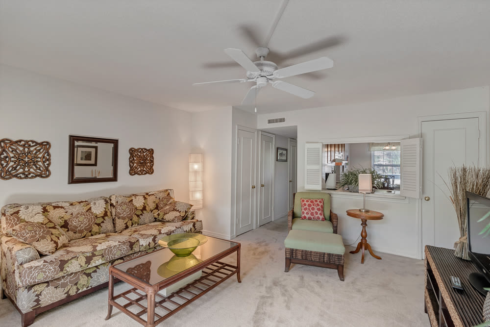 Living room with a comfortable couch and a ceiling fan at Carlton Arms Of St. Petersburg in St Petersburg, Florida 